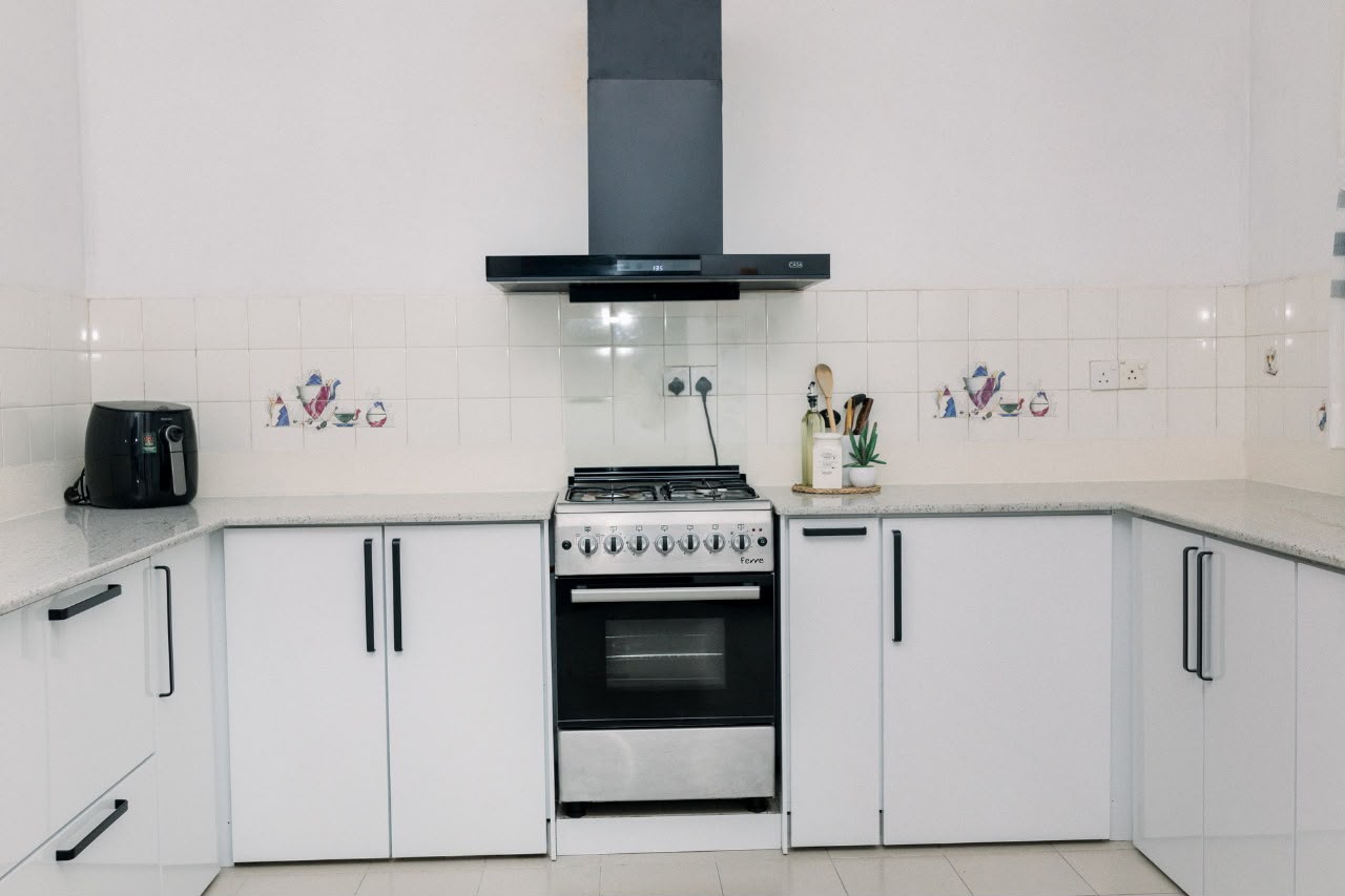 White kitchen with Ferre oven and black chimney hood